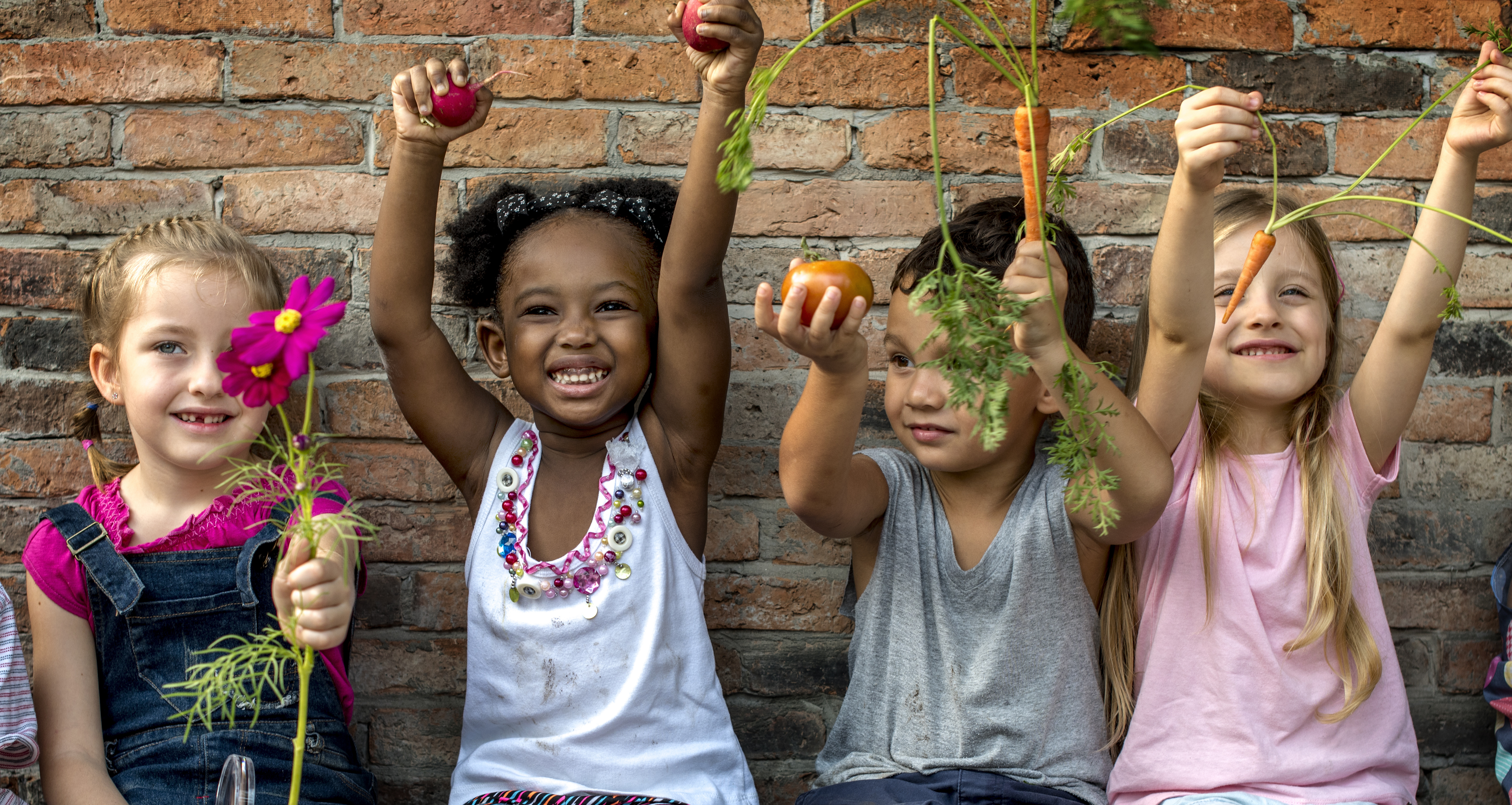 Kids holding veggies
